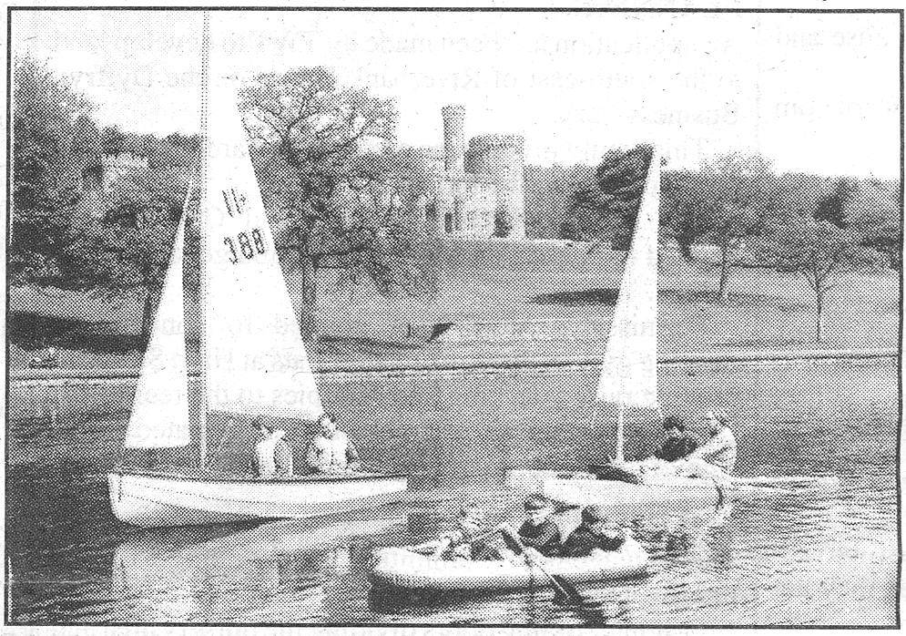 A photo featured in the Merthyr Express in June 2007, showing two small sailing boats and a rubber inflatable boat being rowed, with Cyfarthfa Castle in the background.
